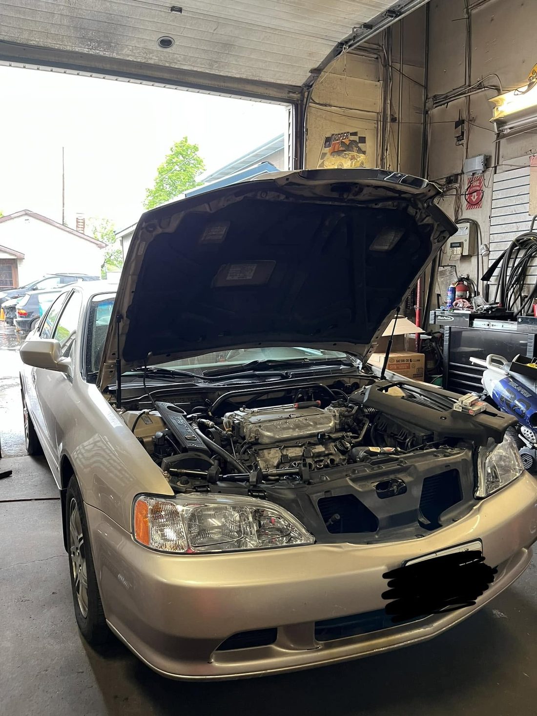 A car up on the bench at Cando's getting service