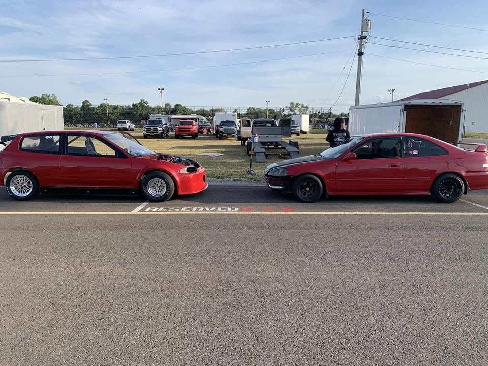 Two built Honda Civics staged at the strip